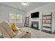 Comfortable living room features a fireplace, and natural lighting from the large window at 4511 Bridgeway Rd, Atlanta, GA 30331