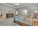 Large main bedroom with tray ceiling, carpet floors, and view into the main bathroom at 4511 Bridgeway Rd, Atlanta, GA 30331