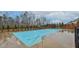 Community pool with clear blue water, surrounded by trees and manicured landscaping with a gazebo in the background at 4511 Bridgeway Rd, Atlanta, GA 30331