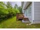 View of the backyard deck, accessible through sliding glass doors and overlooking the lawn at 6590 Smoke Ridge Dr, Atlanta, GA 30349