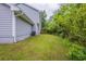 Backyard with grass lawn and wooded area viewed from the side of the house at 6590 Smoke Ridge Dr, Atlanta, GA 30349