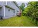 Backyard features lush green grass, siding, and a small deck area at 6590 Smoke Ridge Dr, Atlanta, GA 30349
