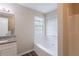 Well-lit bathroom featuring a tub with tile and a granite vanity at 6590 Smoke Ridge Dr, Atlanta, GA 30349