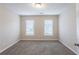 Sunlit bedroom with neutral color palette, plush carpeting, and window at 6590 Smoke Ridge Dr, Atlanta, GA 30349