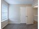 A bright bedroom features carpeting, a window, and a closet for a simple, functional space at 6590 Smoke Ridge Dr, Atlanta, GA 30349
