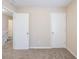 Second floor hallway featuring carpet, doors, and white banister railing at 6590 Smoke Ridge Dr, Atlanta, GA 30349