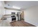 Modern kitchen featuring stainless steel appliances, granite countertops, white cabinets, and hardwood floors at 6590 Smoke Ridge Dr, Atlanta, GA 30349