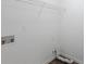 Clean laundry room showcasing white walls, utility connections, and wire shelving at 6590 Smoke Ridge Dr, Atlanta, GA 30349