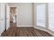 Bright living room with hardwood floors, natural light, and staircase access at 6590 Smoke Ridge Dr, Atlanta, GA 30349
