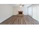 Spacious living room with a brick fireplace, hardwood floors, and large windows with natural light at 6590 Smoke Ridge Dr, Atlanta, GA 30349