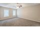 Large main bedroom featuring plush carpet and a ceiling fan at 6590 Smoke Ridge Dr, Atlanta, GA 30349