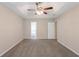 Spacious main bedroom with a tray ceiling and doorway to the en-suite bathroom at 6590 Smoke Ridge Dr, Atlanta, GA 30349