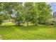 Spacious backyard with mature trees and a well-maintained lawn, perfect for outdoor activities at 3551 Cindy Way, Rex, GA 30273