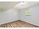A bright bedroom featuring wood-look flooring, neutral walls, and a window at 3551 Cindy Way, Rex, GA 30273