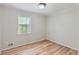 Neutral bedroom with wood-look flooring and a window for natural light at 3551 Cindy Way, Rex, GA 30273