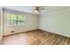 Spacious bedroom featuring wood-look flooring, a ceiling fan, and a bright window at 3551 Cindy Way, Rex, GA 30273