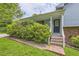 Inviting front porch with brick stairs, green shrubs, and a covered entrance with glass door at 3551 Cindy Way, Rex, GA 30273