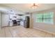 Spacious kitchen with stainless steel appliances, white cabinetry, tile flooring, and ample natural light at 3551 Cindy Way, Rex, GA 30273