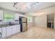 Bright kitchen with stainless steel appliances, white cabinetry, granite countertops, and tile flooring at 3551 Cindy Way, Rex, GA 30273
