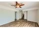 Spacious living room with wood-look flooring, access to the stairs and a hall closet at 3551 Cindy Way, Rex, GA 30273