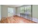 Sunny living room with hardwood floors, large window, and doorway to other rooms at 3551 Cindy Way, Rex, GA 30273