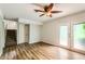 A large living room featuring wood-look flooring and access to a patio and the stairs at 3551 Cindy Way, Rex, GA 30273
