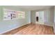 Bright living room featuring hardwood floors, a view of the kitchen, and an open doorway at 3551 Cindy Way, Rex, GA 30273