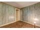 Bedroom featuring outdated wood-paneled walls and worn hardwood floors at 6191 Cumming Hwy, Canton, GA 30115