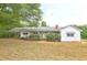 Charming single story home featuring a front porch and established landscaping in a lush green setting at 6191 Cumming Hwy, Canton, GA 30115