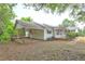 Rear exterior view of home featuring a carport, mature trees, and an expansive yard at 6191 Cumming Hwy, Canton, GA 30115