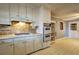 Kitchen featuring vintage appliances, tile backsplash, and worn white cabinets at 6191 Cumming Hwy, Canton, GA 30115