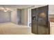 Kitchen area with wood paneled walls, ceiling fan, and black refrigerator at 6191 Cumming Hwy, Canton, GA 30115
