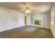 Neutral carpet in a room with a ceiling fan and painted brick fireplace at 6191 Cumming Hwy, Canton, GA 30115