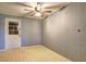 Room with a vintage ceiling fan, wood paneling, and adjacent doorway at 6191 Cumming Hwy, Canton, GA 30115