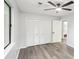 Bright bedroom featuring hardwood floors, ceiling fan, closet and neutral color scheme at 6700 Knollwood Cir, Douglasville, GA 30135