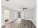 Spacious bedroom with gray vinyl floors, ceiling fan, and access to outdoor balcony at 6700 Knollwood Cir, Douglasville, GA 30135