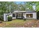 Charming home with black trim, white siding, and a well-maintained yard at 6700 Knollwood Cir, Douglasville, GA 30135