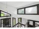 Bright foyer featuring large windows, a modern light fixture, and a contemporary staircase at 6700 Knollwood Cir, Douglasville, GA 30135