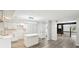 Open kitchen with white cabinets, island, and stainless steel sink at 6700 Knollwood Cir, Douglasville, GA 30135
