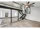 Bright living room featuring modern gray flooring and unique staircase and lighting at 6700 Knollwood Cir, Douglasville, GA 30135
