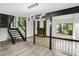 Upstairs living area boasts modern lighting, fireplace, gray flooring, and stairs at 6700 Knollwood Cir, Douglasville, GA 30135