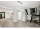 Open floor plan featuring modern gray floors, white walls, and a modern lighting fixture at 6700 Knollwood Cir, Douglasville, GA 30135