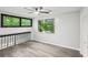 Versatile loft space with gray vinyl flooring and bright windows with scenic backyard views at 6700 Knollwood Cir, Douglasville, GA 30135