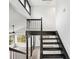 View of staircase and open upstairs area with white walls and black railing at 6700 Knollwood Cir, Douglasville, GA 30135
