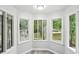 Cozy sunroom featuring multiple windows offering ample natural light and serene views at 6700 Knollwood Cir, Douglasville, GA 30135