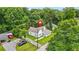 Charming home surrounded by lush trees, featuring a well-manicured lawn and a welcoming entrance at 6802 Ida St, Lithonia, GA 30058