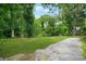 Expansive backyard with large trees and a partially shaded area, perfect for outdoor activities at 6802 Ida St, Lithonia, GA 30058