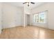 A cozy bedroom with hardwood floors, a closet, and a ceiling fan at 6802 Ida St, Lithonia, GA 30058