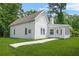 Charming cottage-style home featuring white siding and a well-manicured front lawn at 6802 Ida St, Lithonia, GA 30058