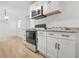 Updated kitchen with white cabinets, modern appliances, and granite countertops at 6802 Ida St, Lithonia, GA 30058